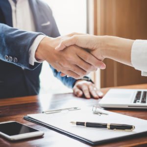 Real estate agent and customers shaking hands together celebrating finished contract after about home insurance and investment loan, handshake and successful deal