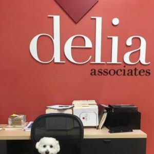 Jeter sitting in front of Delia Associates logo