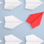 Change concepts with red paper airplane leading among white