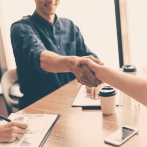 close up. financial partners shaking hands over the Desk